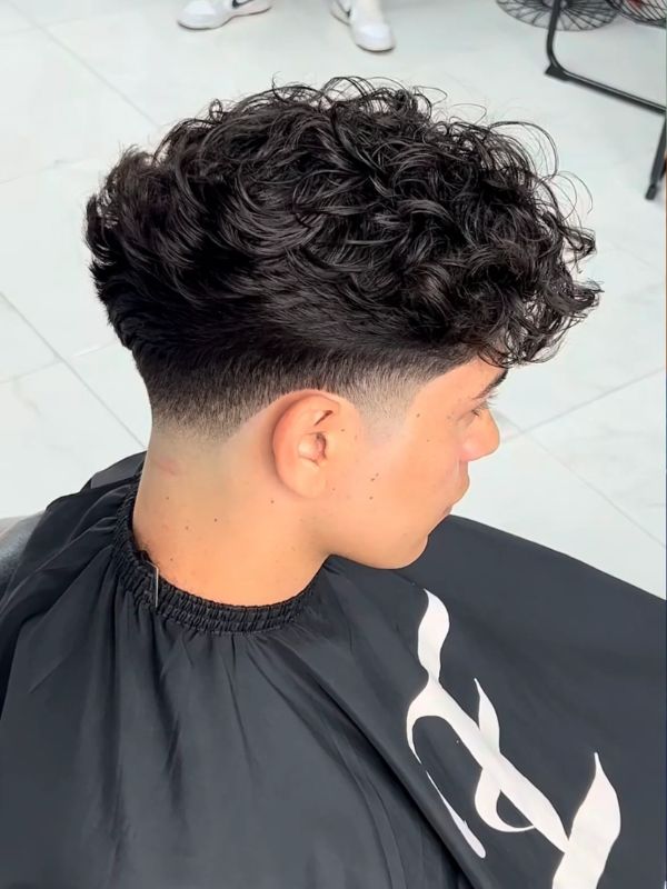 Low Taper Fade Curly Hair Mohawk Style