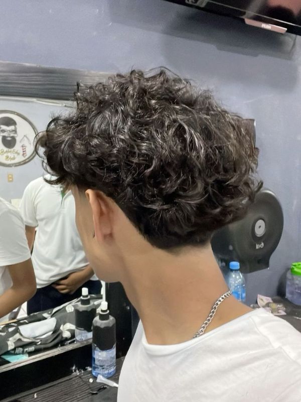 Low Taper with Curly Hard Part