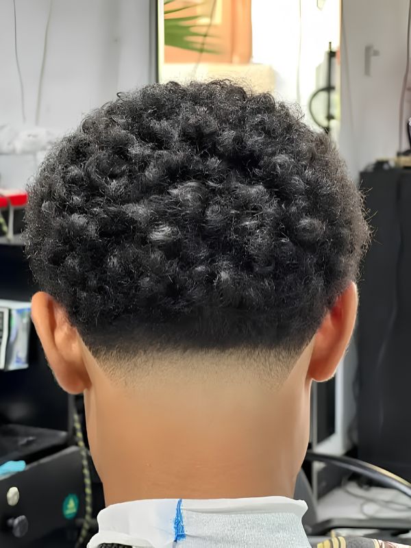 Layered Curls Complemented by a Low Taper Fade